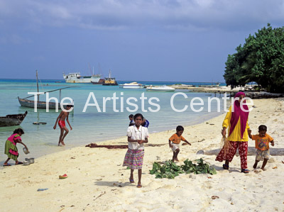 Local children playing on beach Maldives Indian Ocean