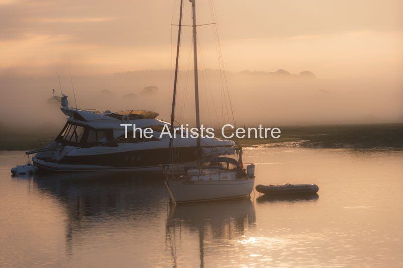Misty morning peaceful setting of boats moored