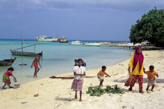 Local children playing on beach Maldives Indian Ocean